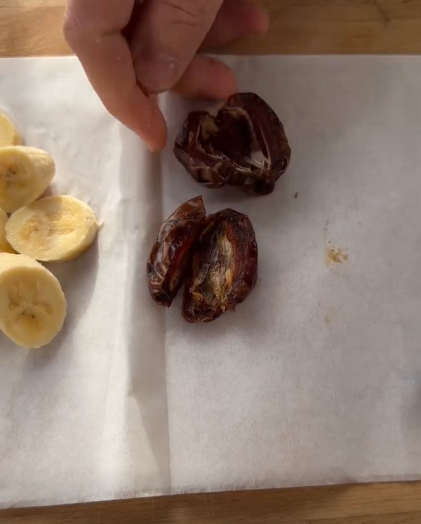 Line a small baking sheet or plate with parchment paper. Slice pitted Medjool dates open and press them down side-by-side on the parchment, slightly overlapping them to create a solid date rectangle.