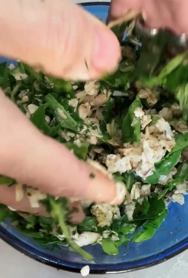 In a bowl, combine the crumbled matzah, eggs, chopped fresh spinach, and grated cheese/seasonings. Mix well to coat the matzah.
