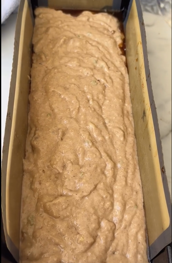 Pour the cake batter into a greased and parchment paper-lined loaf tin or round cake pan. Slice the remaining 1 apple thinly and arrange the slices neatly over the top of the batter.