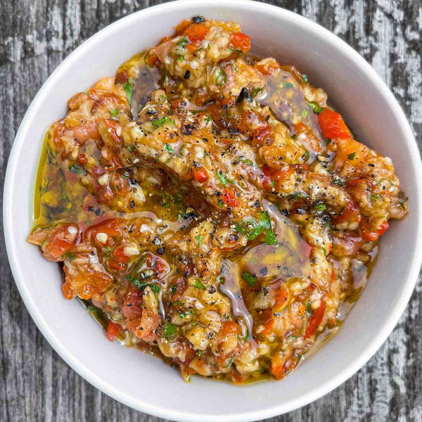Present the smoky, vibrant roasted
eggplant and pepper salad served over a rich bed of labneh or tahini, looking like
a million bucks with zero effort.