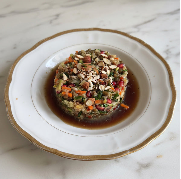 Pour dressing over salad, toss gently, and top generously with fresh pomegranate seeds and toasted pine nuts.