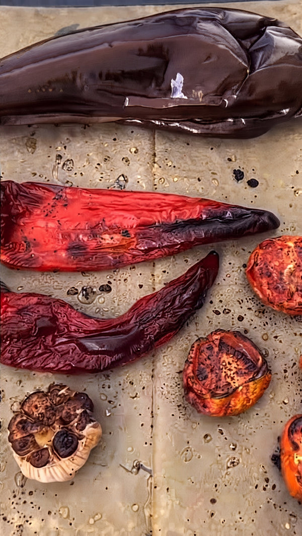 Roast the eggplants and red bell
peppers directly over an open fire or grill until charred and smoky.