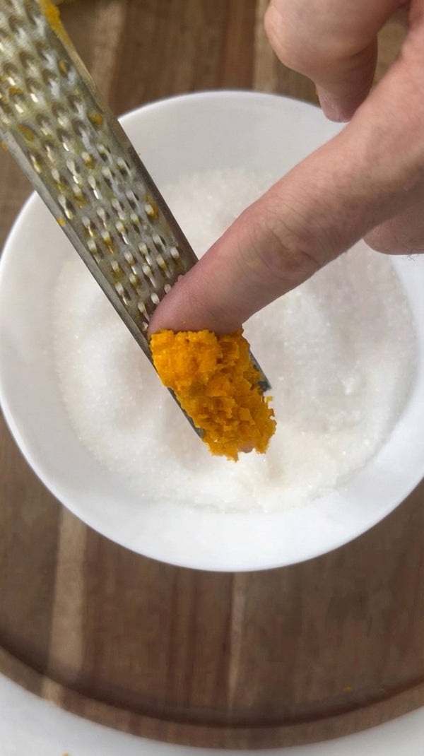 Grate the outer layer (zest) of fresh oranges or lemons and rub it thoroughly into the sugar so that the natural citrus oils are absorbed, enhancing the flavor.