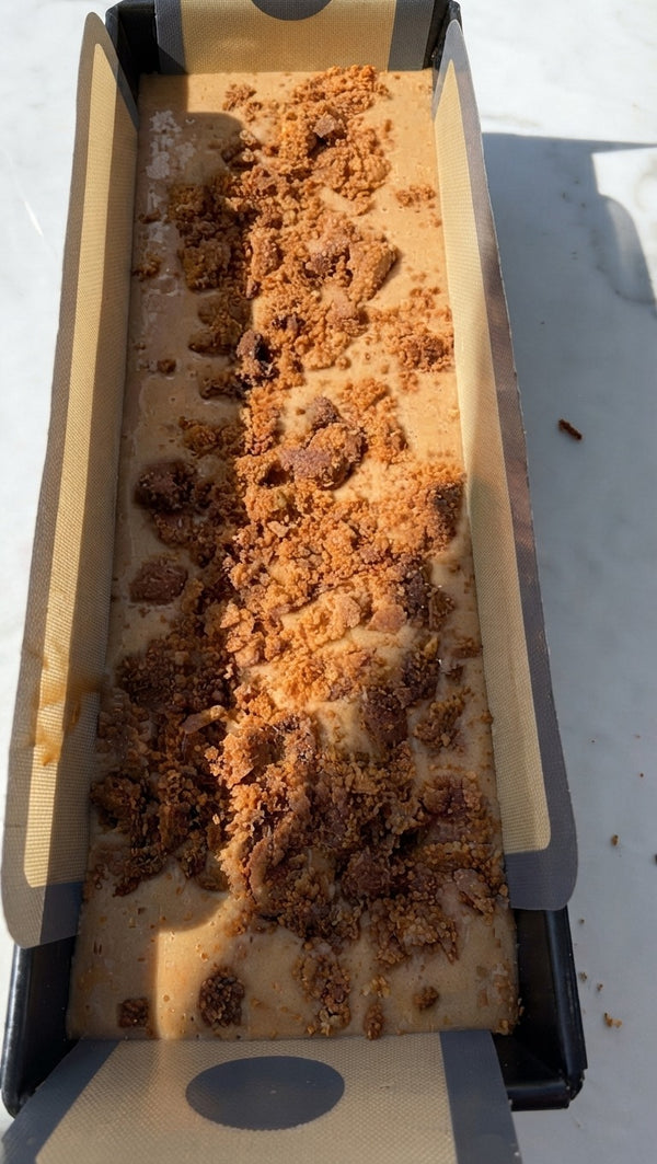 Scatter a generous layer of crumbly, sweet cinnamon streusel mixture evenly down the center and across the surface of the batter inside the pan.