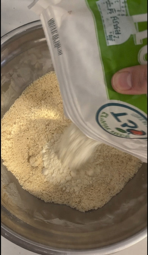 Pour in additional flour or powdery dry components.