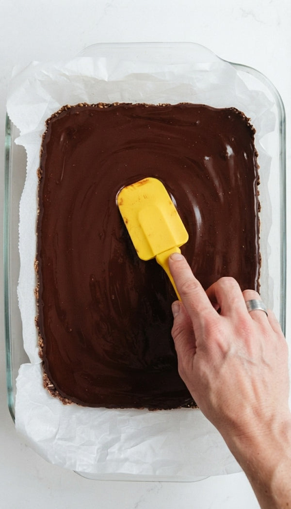 Pour chocolate ganache evenly over the nut layer and smooth out.
