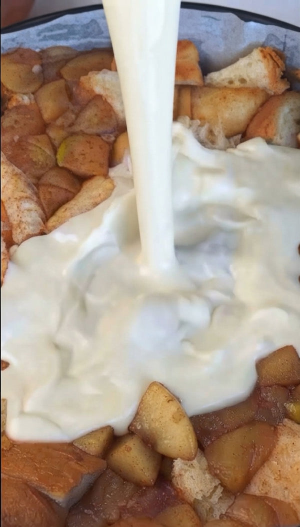 Pour a rich, smooth milk or cream custard mixture evenly over the bread and apples