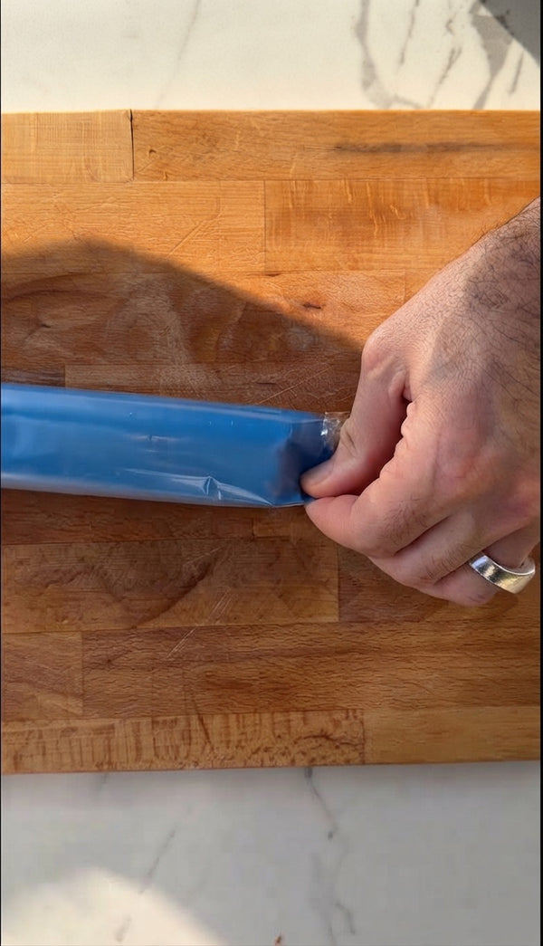 The process begins by removing the protective plastic wrapping from a block of dough (likely phyllo or a similar pastry dough).