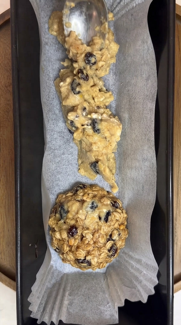 Line a loaf pan with parchment paper, then transfer and press portions of the prepared batter into the pan using a spoon or spatula
