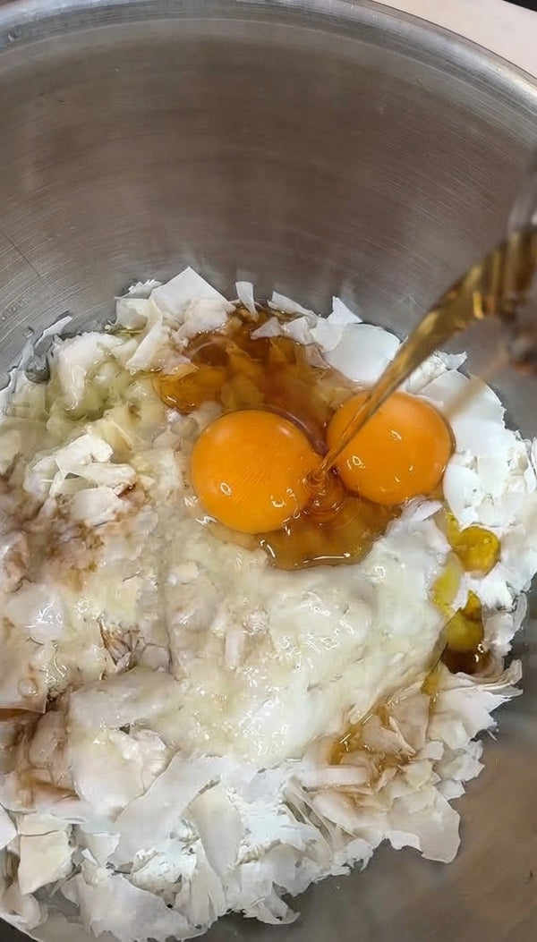 In a large mixing bowl, combine the shredded pastry shards with eggs and liquid sweeteners or oils.