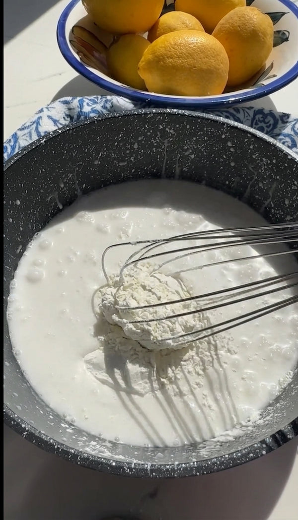 Place the pan over medium heat and whisk continuously until the mixture comes to a gentle simmer and thickens into a glossy, smooth pudding texture.
