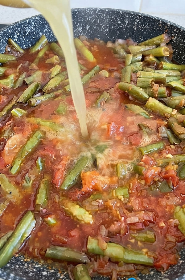 Stir in the crushed tomatoes and half of the fresh tarragon/herb leaves. Return the chicken quarters back into the pot.