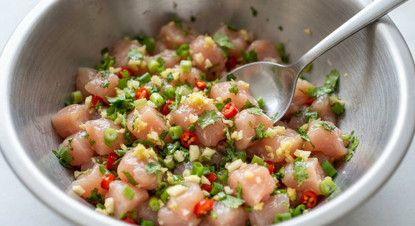 Season chicken cubes with salt, black pepper, cayenne or paprika, and a touch of oil. Mix well.