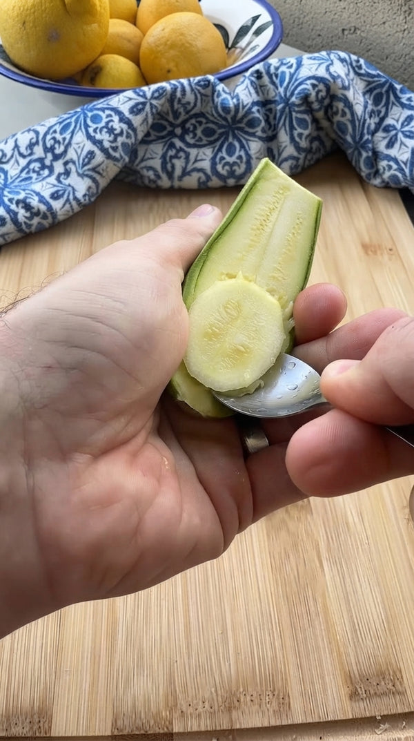 Slice zucchinis in half lengthwise. Use a small spoon to scoop out the center core to create 