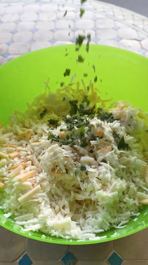 In a bowl, combine crumbled Bulgarian cheese, grated Mozzarella, Ricotta, egg yolk, and 1 tablespoon of Za'atar until rich and well incorporated.