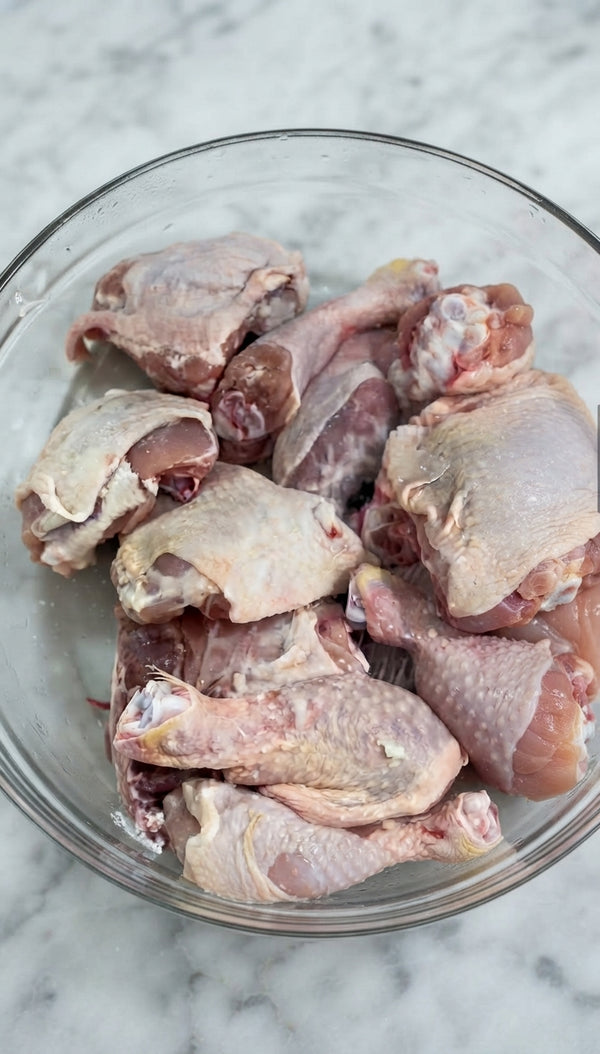 Pour marinade over chicken and potatoes, massaging it evenly over all sides.