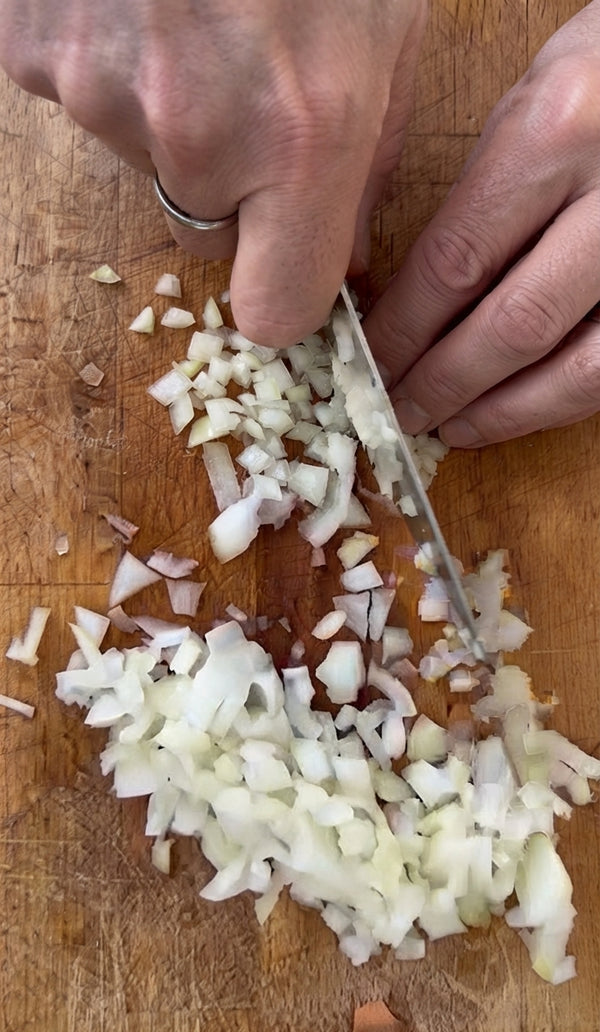 Heat a drizzle of olive oil in a skillet over medium heat. Add the chopped onion and sauté until translucent. Add minced garlic and cook for 1 minute until golden and fragrant.