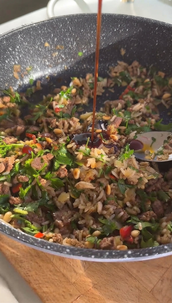 Stir in pine nuts, Baharat, cinnamon, salt, and pepper. Remove from heat and mix in cooked rice or cauliflower rice.