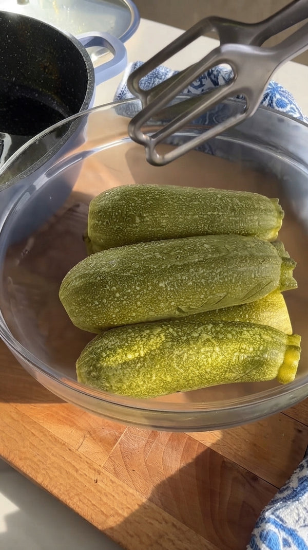 Wash zucchini. Instead of coring them out, simply cut a single longitudinal slit down the middle of each zucchini, creating a deep pocket while keeping ends intact.