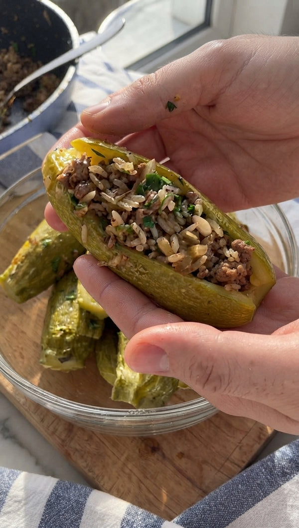 Gently open the scored slit in each zucchini and pack generously with the seasoned meat mixture.