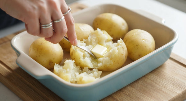 Boil potatoes until fork-tender. Peel and mash until completely smooth while warm. Stir in butter, salt, pepper, and nutmeg.