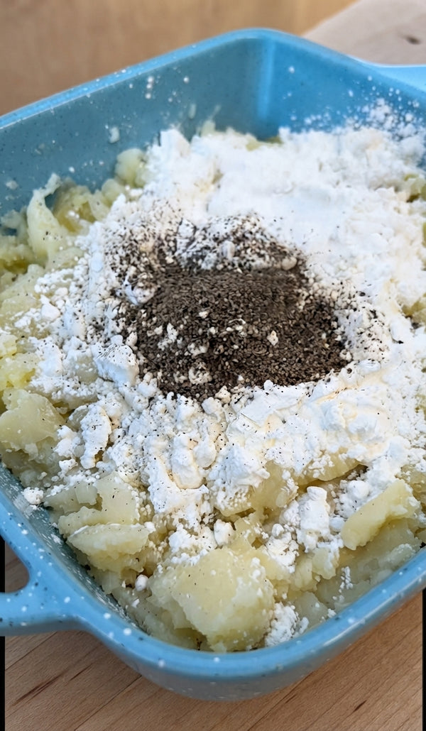 Fold in grated Pecorino, crumbled Le Logis goat cheese, and egg yolk into the potato mixture until uniform.