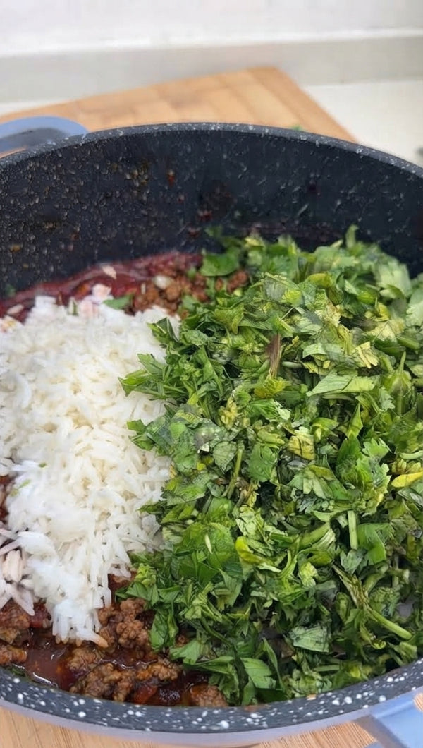Sauté diced onions in olive oil until golden. Combine rinsed rice, sautéed onion, herbs, grated veggies/surprises, tomato paste, and spices in a bowl.