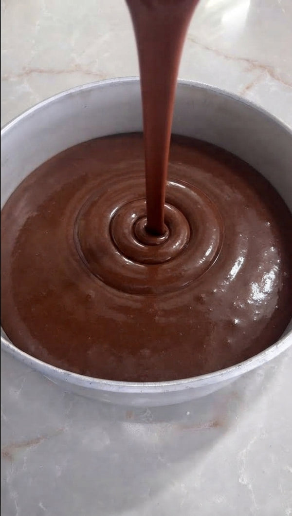 Gently fold the melted chocolate mixture into the whipped eggs using a spatula until fully combined.