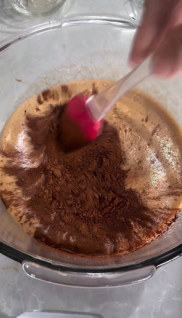 Sift in 2 tablespoons of cocoa powder and gently fold into the chocolate batter.