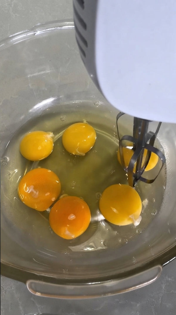 In a separate mixing bowl, beat eggs and sugar with an electric hand mixer for 3–5 minutes until pale, thick, and fluffy.