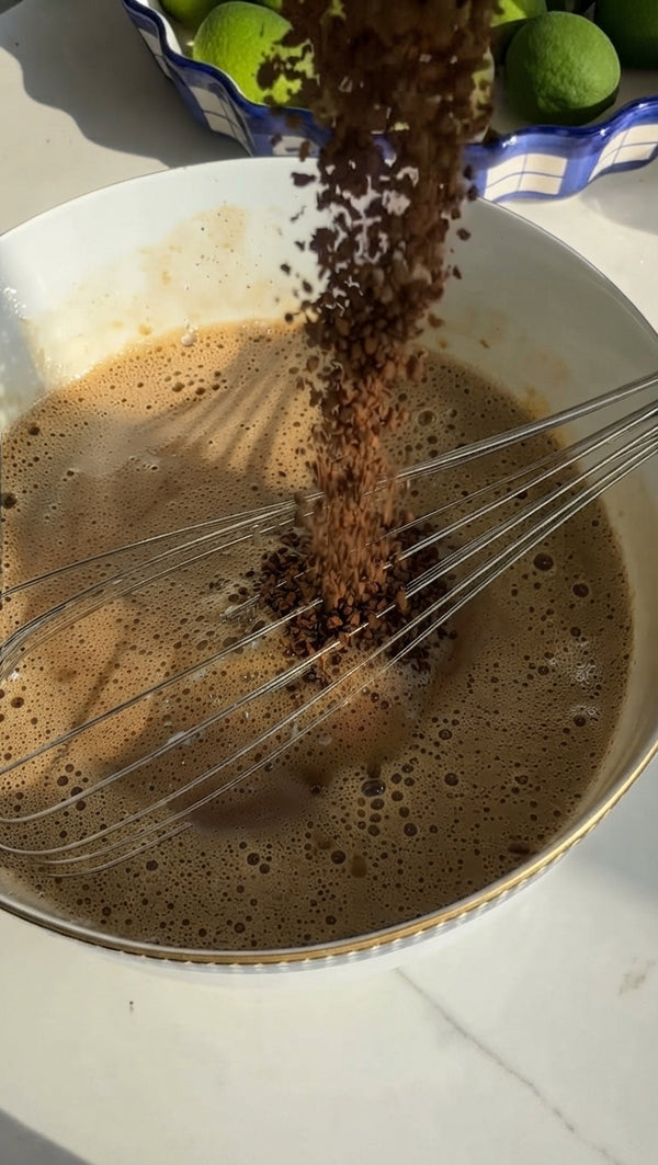 Sift in the flour, baking powder, baking soda, ground cinnamon, optional cloves, and a pinch of salt. Whisk gently just until a uniform batter forms—do not overmix.