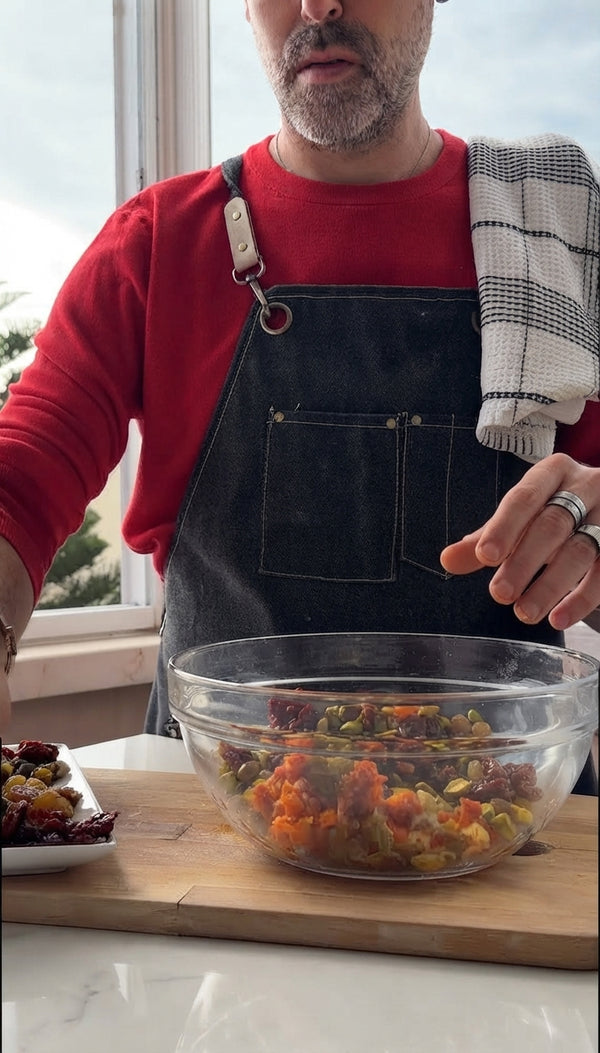 Transfer cooked carrots and onions to a mixing bowl. Add drained soaked bulgur, chopped dried fruits, charred cinnamon stick, salt, black pepper, and Ras el Hanout. Mix thoroughly and allow to cool slightly.