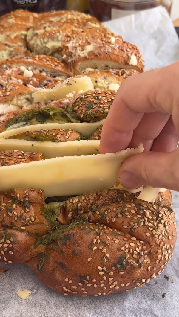 Stuff slices of Basher Fromagerie melting cheeses generously into all the slits of the challah until packed full.
