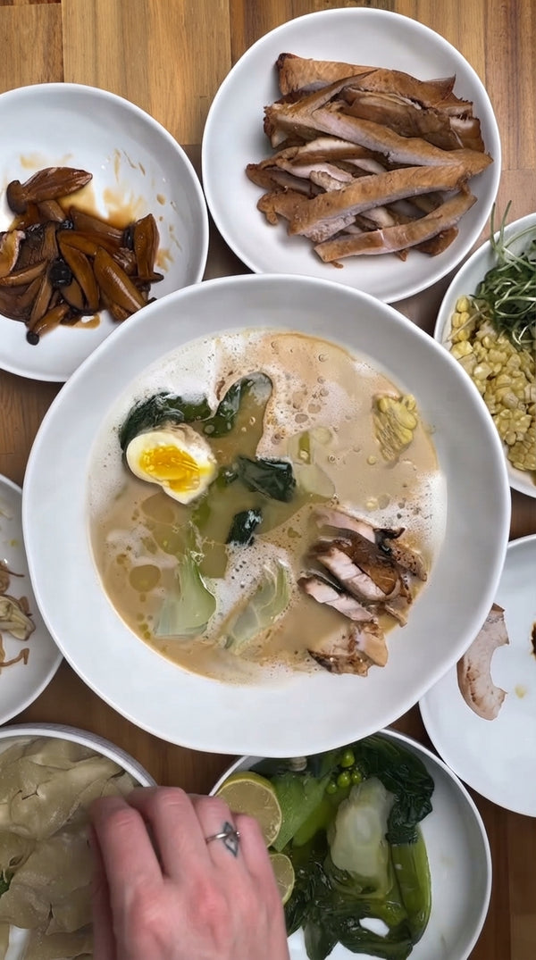 Cook ramen noodles separately in boiling water according to package
directions and drain. Spoon 1–2 tablespoons of hot tare into the bottom of each serving
bowl, ladle in hot, emulsified Tori Paitan broth, and mix. Add cooked noodles, then

neatly arrange sliced chicken chashu, halved ramen egg, bok choy, corn, and fresh
vegetables on top.