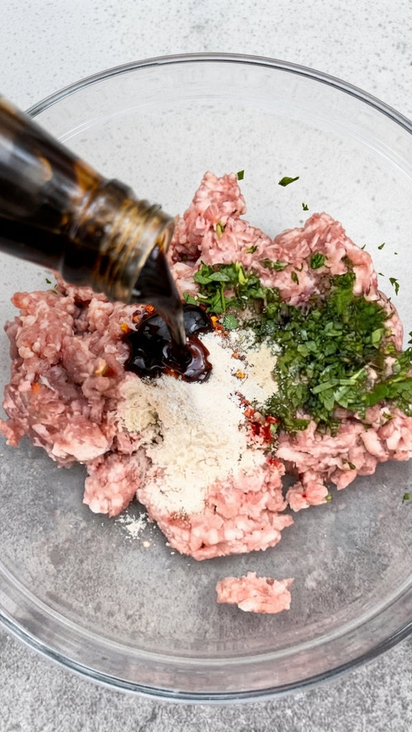 In a mixing bowl, combine ground beef, chopped cilantro, minced Thai chilies, garlic, cornstarch, fish/soy sauce, brown sugar, salt, and black pepper.