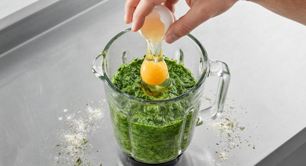 Blend blanched, dried spinach with eggs until completely smooth and bright green. Mound flour on a work surface, form a well in the center, and pour in the spinach-egg mixture. Gradually incorporate flour and knead for 8–10 minutes until smooth and elastic. Wrap in plastic wrap and rest for 30 minutes.