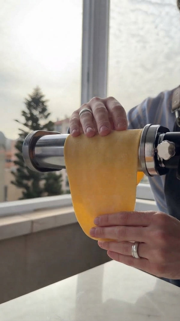 Attach the pasta roller attachment to the stand mixer (Speed 3). Gradually roll rested dough into thin sheets, then cut into fettuccine or tagliatelle strands. Dust lightly with flour and cover with a towel.