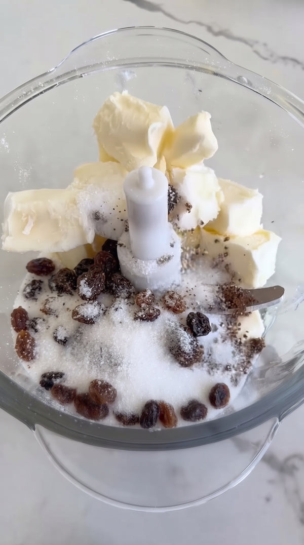 Combine flour, cold cubed butter, sugar, baking powder, and salt in the food processor bowl. Pulse a few times until a coarse sandy crumb texture forms.