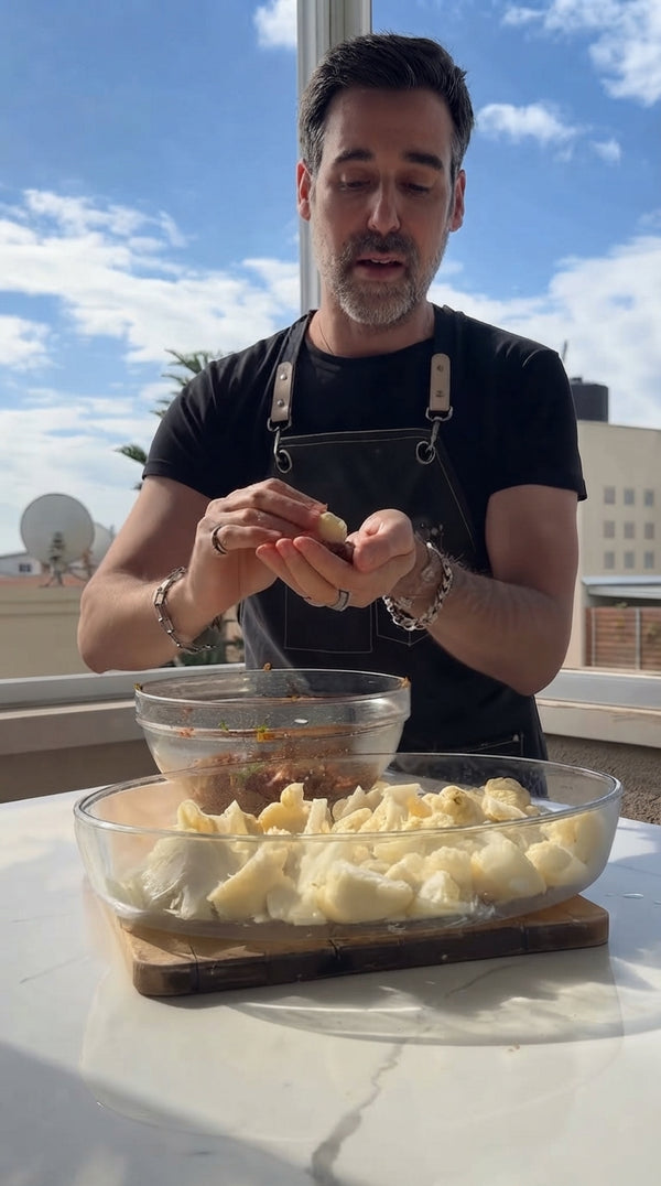 Take a small cauliflower floret, wrap it completely inside a portion of the meatball mixture, and shape into a closed, uniform meatball with a
hidden cauliflower center. Arrange in a wide pot or baking dish.