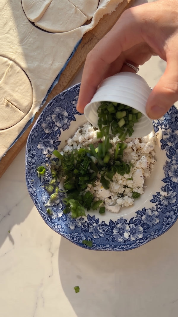 In a bowl, combine crumbled Bulgarian cheese, grated Kaskaval, cottage cheese, egg, black pepper, and nutmeg until well mixed.