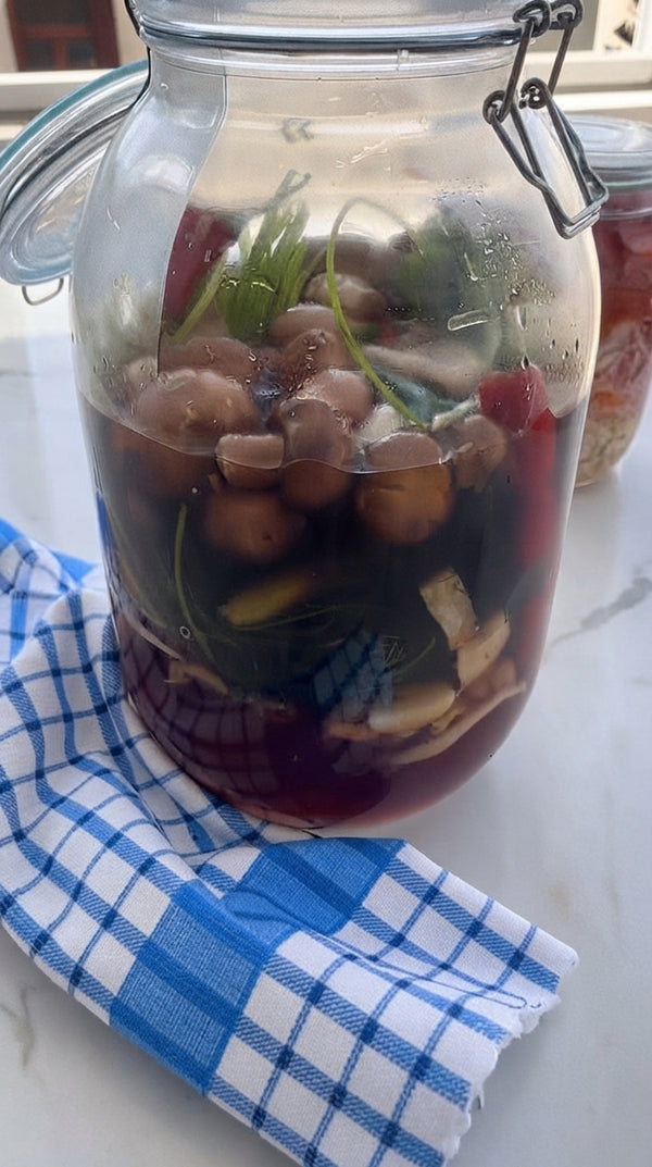 Pack mushrooms tightly into a clean glass jar. Pour seasoned brine over mushrooms until completely submerged (use a fermentation weight if needed).
