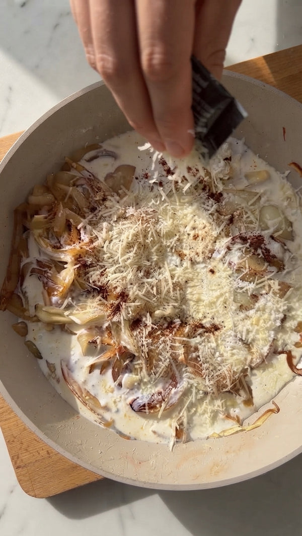 Toss cooked pasta directly in the onion sauce. Stir in grated Parmesan until glossy and melted.