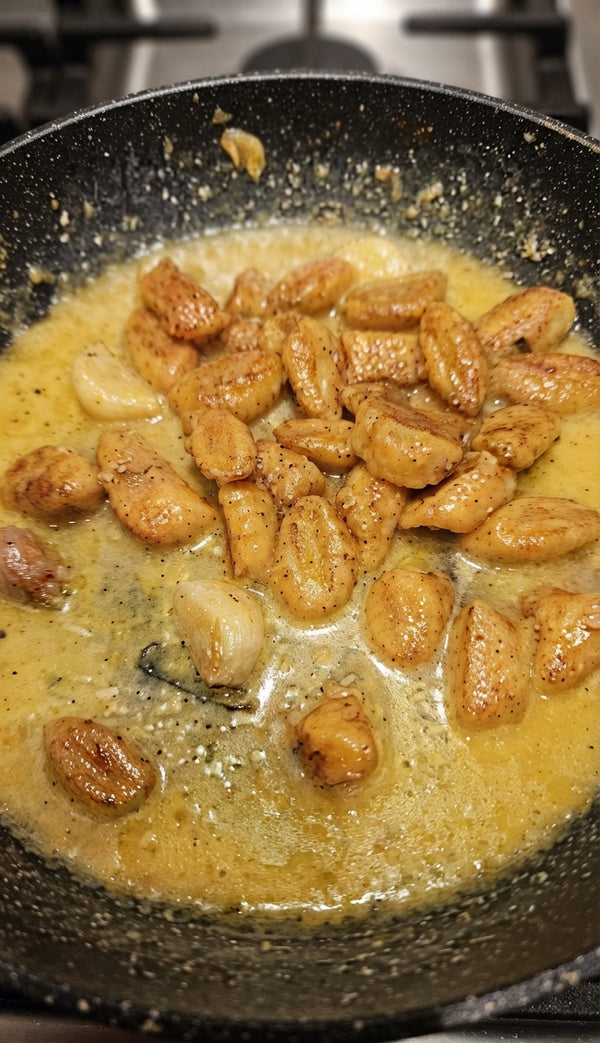 Transfer cooked gnocchi directly into a skillet with warm melted butter, basil, and grated Parmesan cheese. Toss gently for 1 minute and serve immediately.