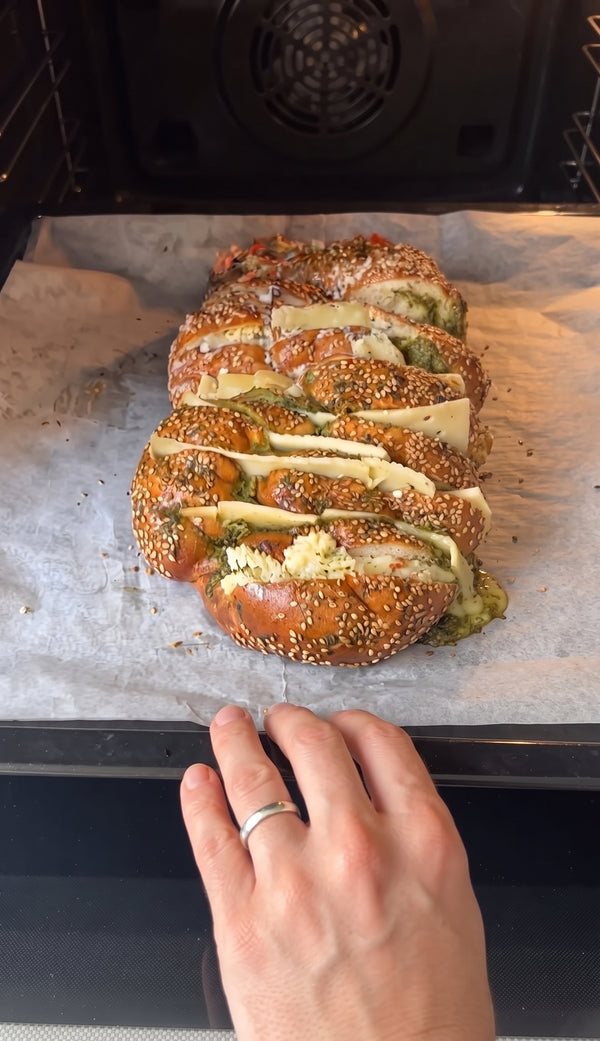 Wrap loosely in parchment paper or foil and bake in a preheated oven at 190°C (375°F) for 10–12 minutes. Uncover for the last 3–5 minutes until the cheese is bubbling, gooey, and the top crust is crispy and golden.