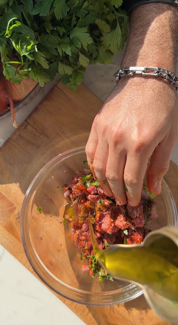 Heat oil in a wide cast-iron skillet or griddle over medium-high heat. Place pitas meat-side down and cook for 3–4 minutes until beef is deeply seared and caramelized. Flip and cook pita-side for 1–2 minutes until crispy.