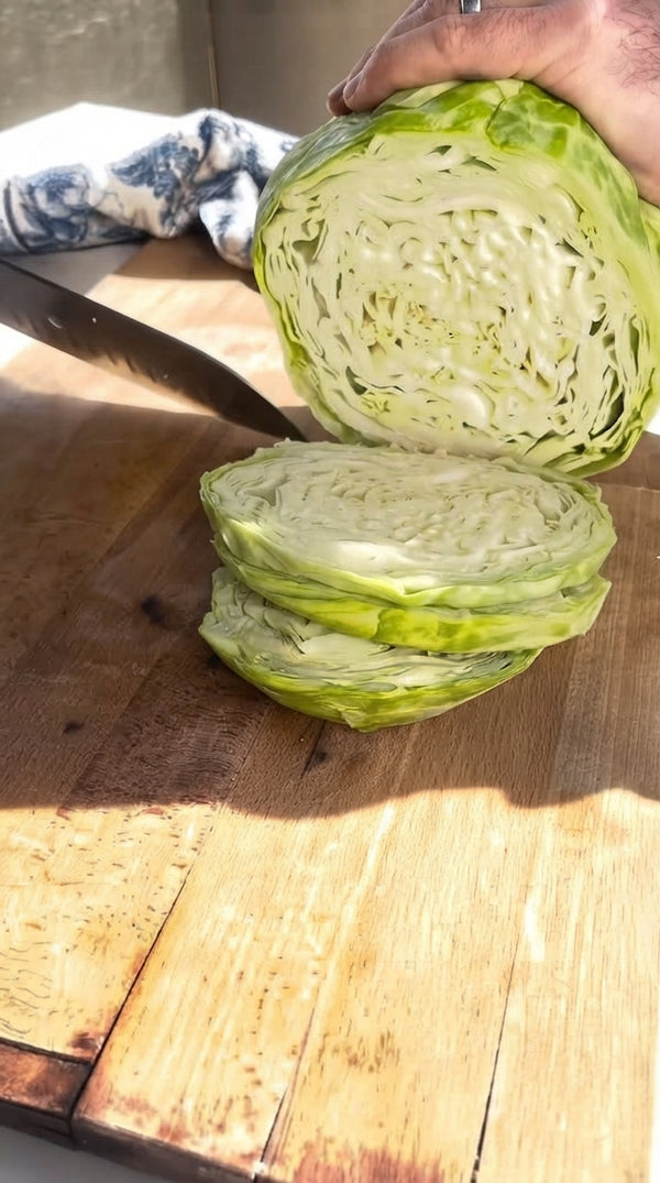 Cut the head of cabbage into wedges, keeping the core intact so the leaves hold together. Carefully create slits/pockets between the inner leaves.