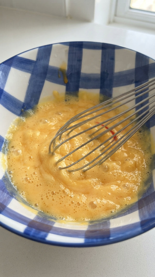 In a single large bowl, whisk eggs, sugar, oil, orange juice (or milk), and vanilla extract using a hand whisk until smooth.