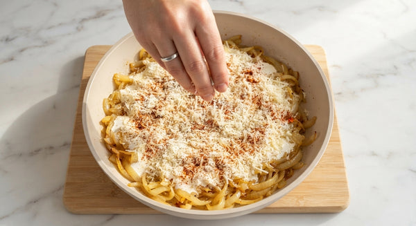 Transfer cooked pasta directly into the warm sauce pan. Toss with a splash of reserved pasta water until glossy and perfectly coated. Serve immediately topped with grated Parmesan, black pepper, and fresh thyme or chives.