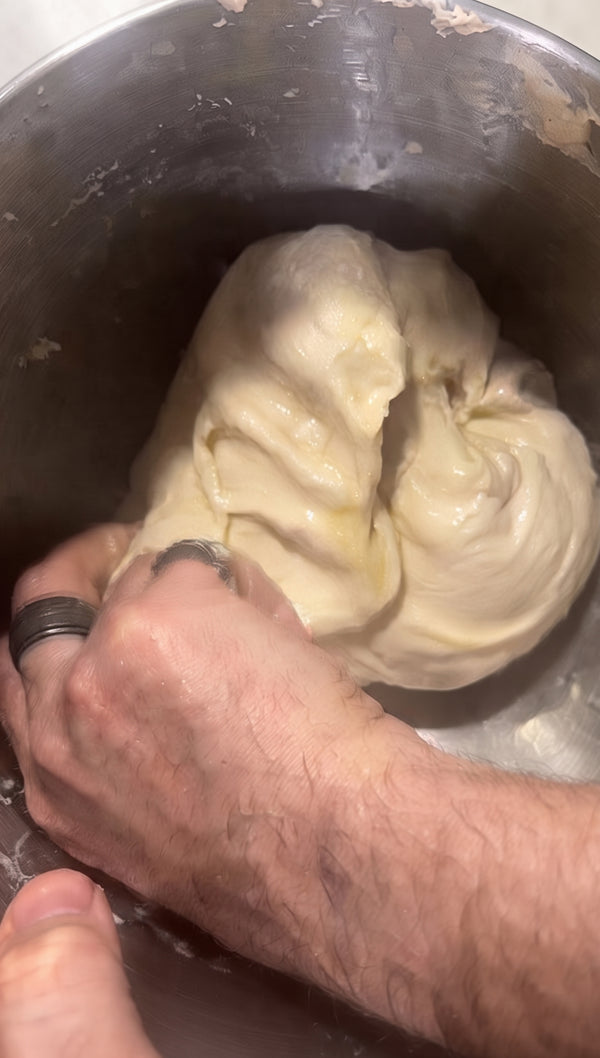 Generously coat a round metal baking pan with olive oil. Transfer sticky dough and press out with oiled fingertips.