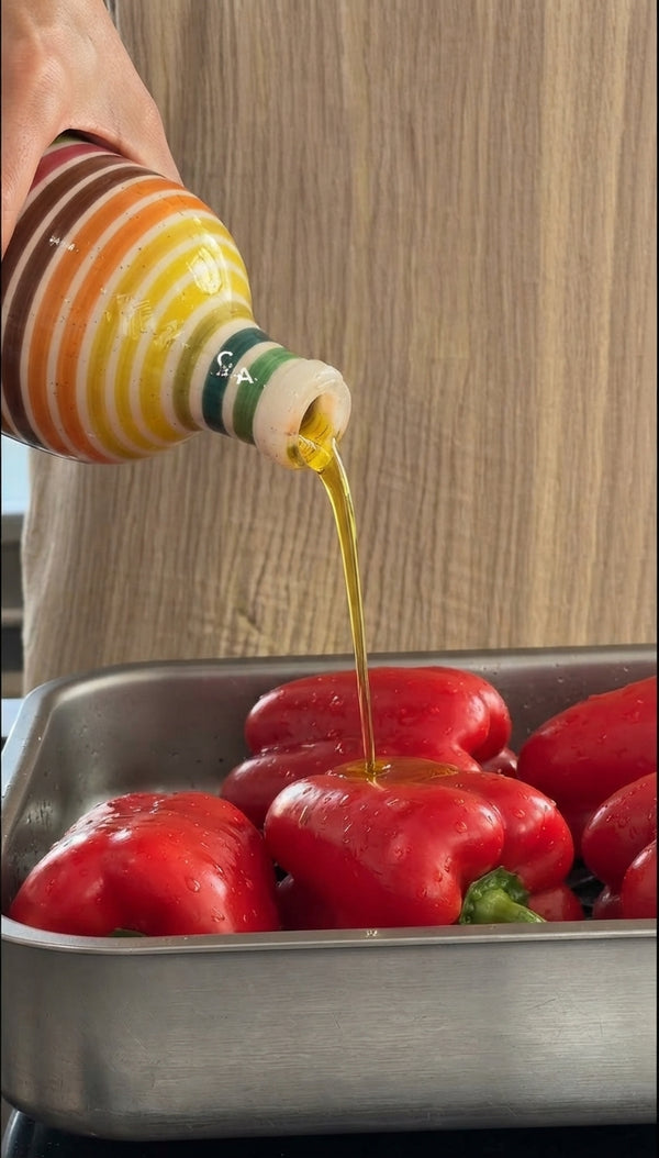 Roast sweet bell peppers and hot chili in the oven with olive oil and salt. Place hot peppers in a sealed container for 30 minutes to steam, then peel off skins. Blend peeled peppers with extra virgin olive oil, salt, black pepper, and fresh lemon juice until smooth.